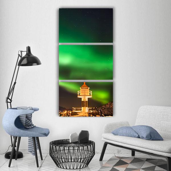 Aurora Over Lofoten Lighthouse Vertical Canvas Wall Art in black and green, single vertical panel hung on a wall