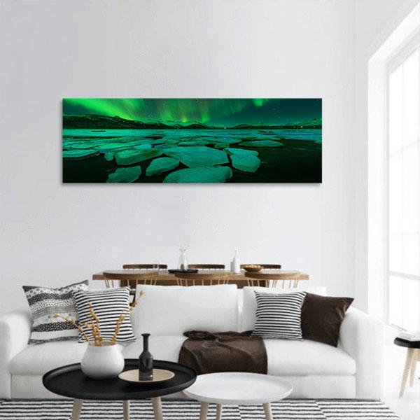 Northern Lights Over Iceland Ice Floes Panoramic Canvas Wall Art in black, green and blue, single panel hung on a wall