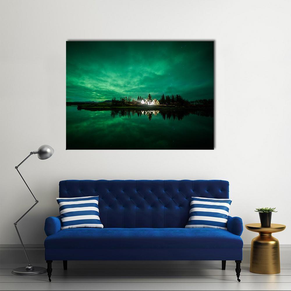 Aurora Borealis Over Lakeside Village Canvas Wall Art in black and green, single panel hung on a wall