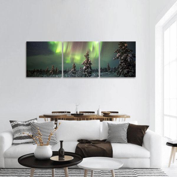 Aurora Borealis Over Snow-covered Pines Panoramic Canvas Wall Art in black, white and green, single panel hung on a wall