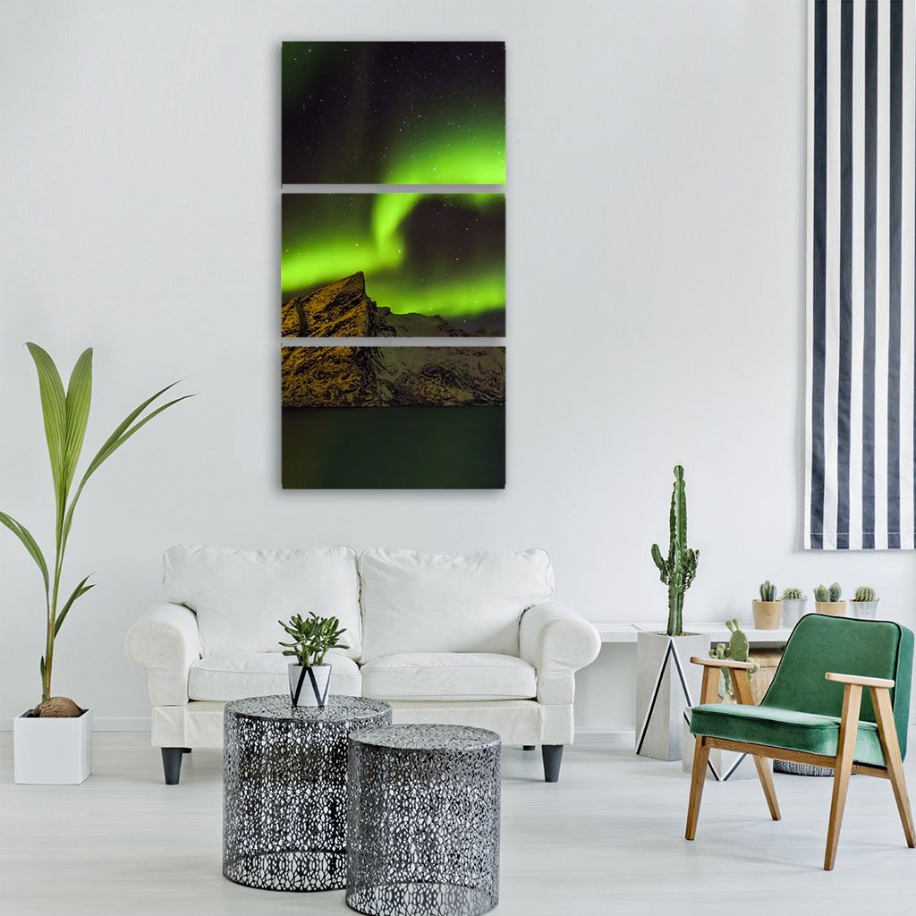 Aurora Borealis Over Lofoten Islands Vertical Canvas Wall Art in black and green, single vertical panel hung on a wall