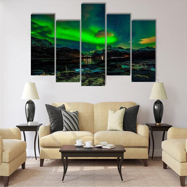 Aurora Borealis Over Mountains Canvas Wall Art in black, green and blue, 5 panel Pop layout hung on a wall
