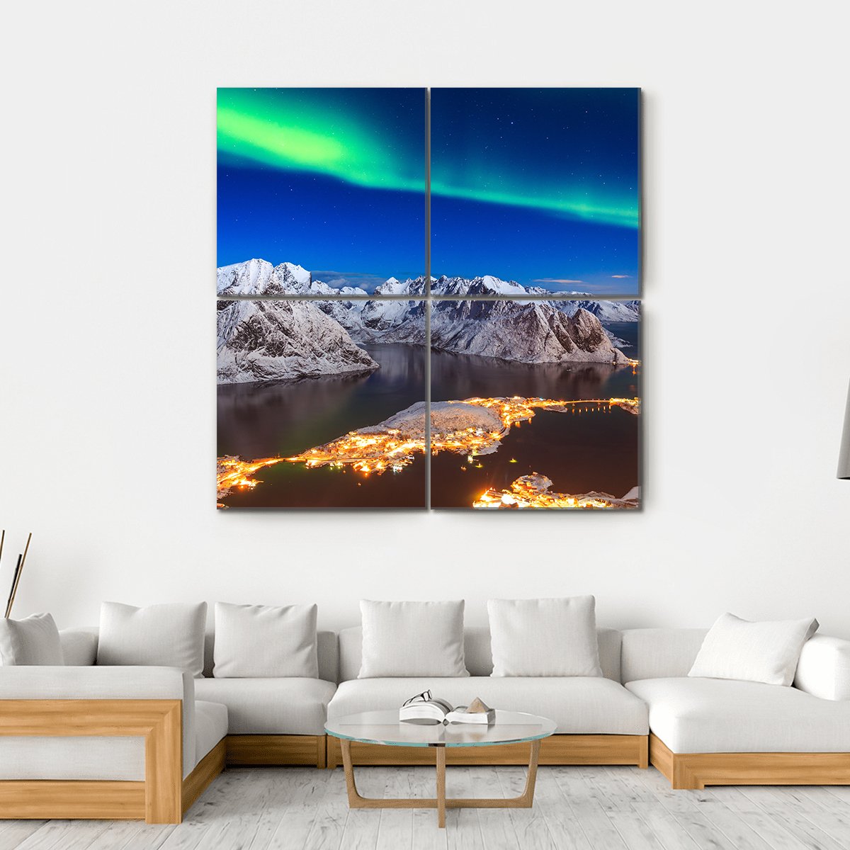 Aurora Over Snowy Mountain Village Canvas Wall Art in white, green and blue, hung on a wall