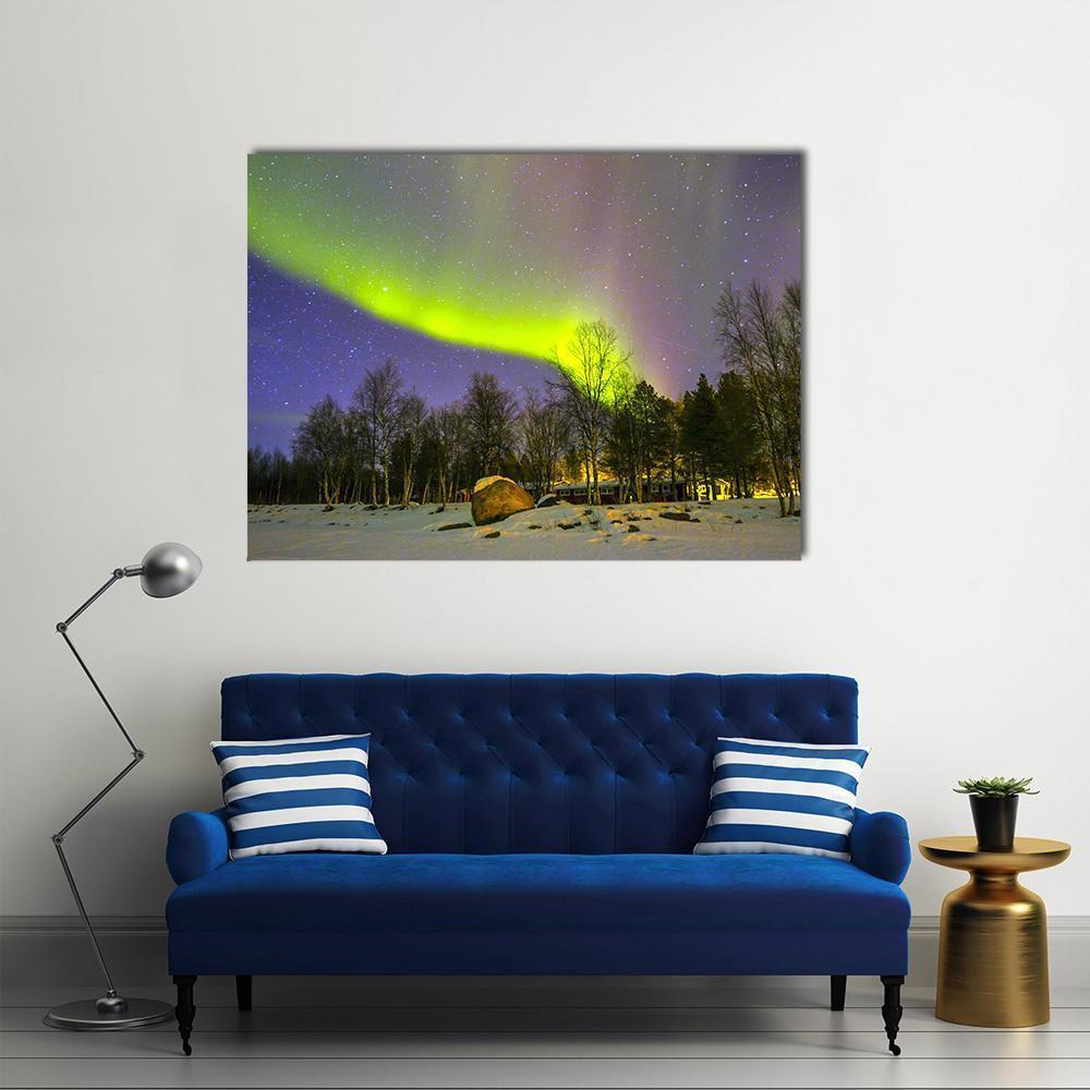 Aurora Borealis Over Snowy Landscape Canvas Wall Art in white, green and purple, single panel hung on a wall