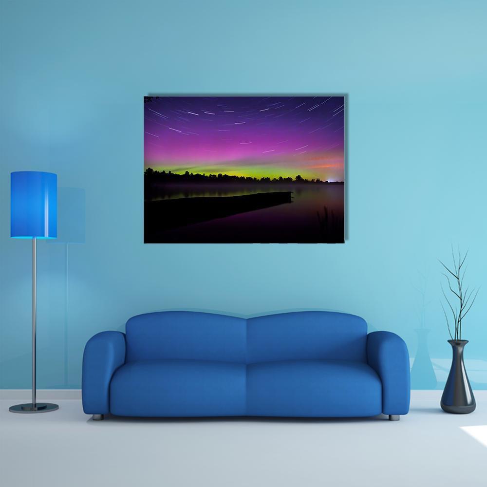Aurora Borealis Over Lake and Dock Canvas Wall Art in black, green and purple, single panel hung on a wall
