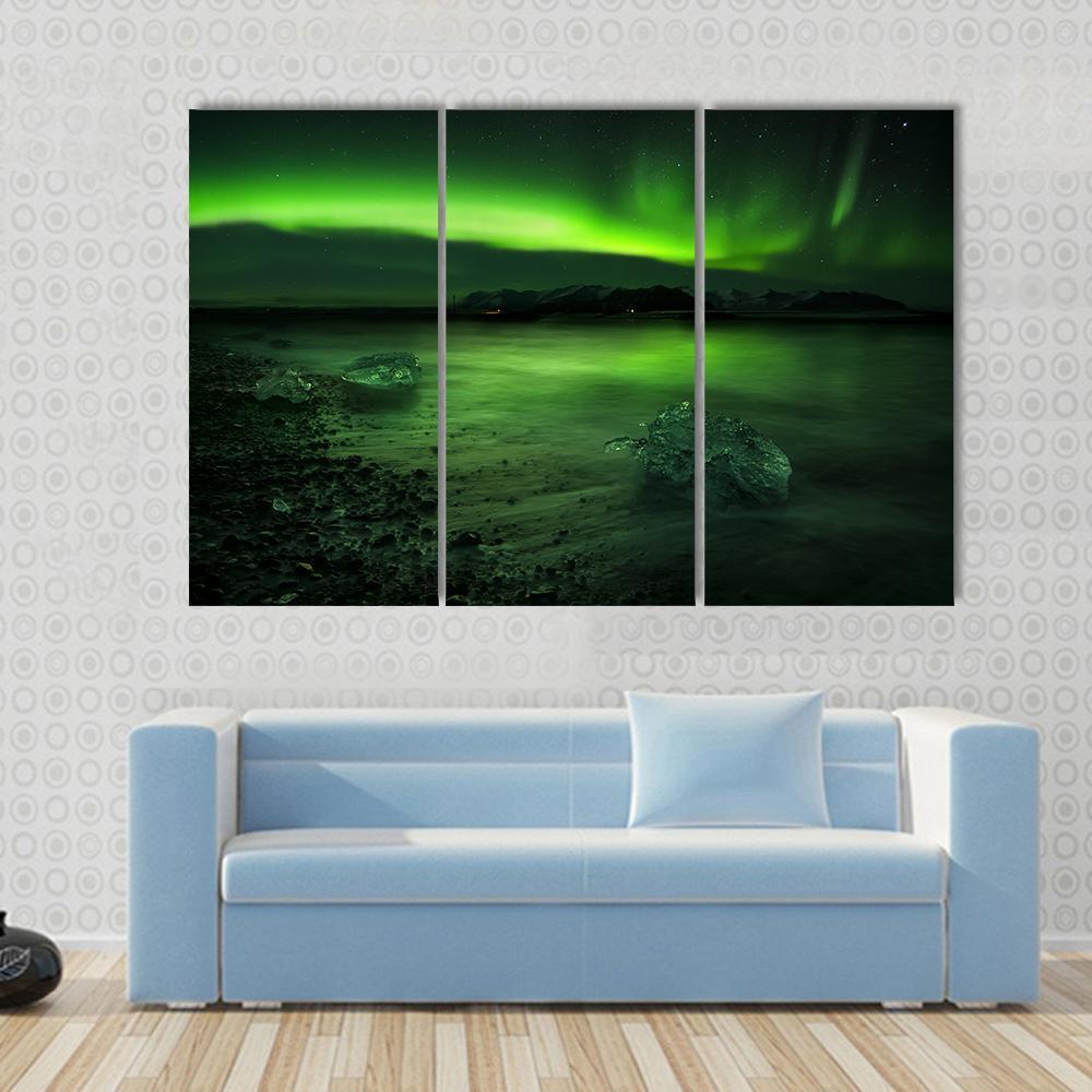 Aurora Northern Lights Canvas Wall Art in black and green, 4 panel Pop layout hung on a wall
