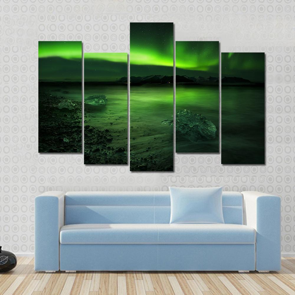 Aurora Northern Lights Canvas Wall Art in black and green, 4 panel Pop layout hung on a wall