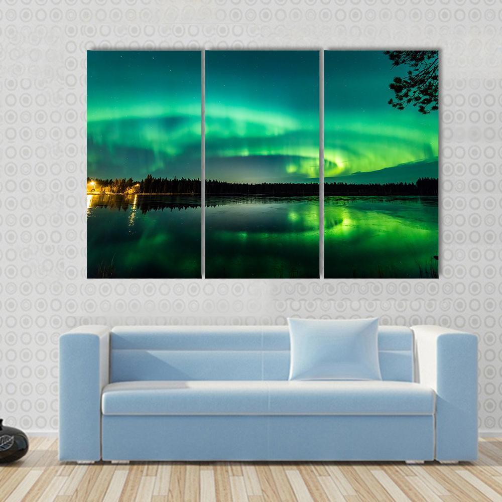 Aurora Over Finnish Lake Canvas Wall Art in black and green, 5 panel Star layout hung on a wall
