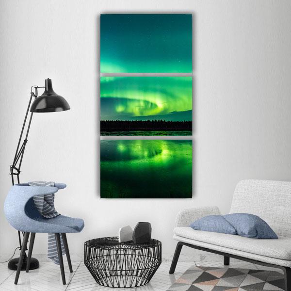 Aurora Borealis Over Lake Reflection Vertical Canvas Wall Art in black and green, single vertical panel hung on a wall