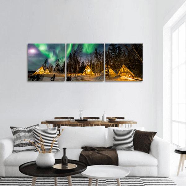 Aurora Over Snowy Tipis Panoramic Canvas Wall Art in black, yellow and green, single panel hung on a wall