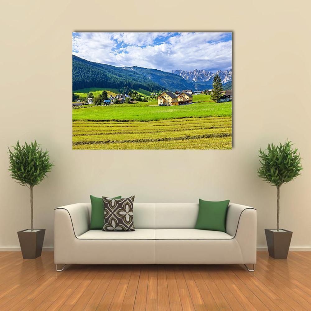 Austrian Village and Meadows Canvas Wall Art in yellow, green and blue, single panel hung on a wall
