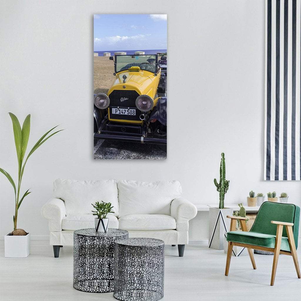 Yellow Classic Convertible Car Vertical Canvas Wall Art in black, yellow and blue, single vertical panel hung on a wall