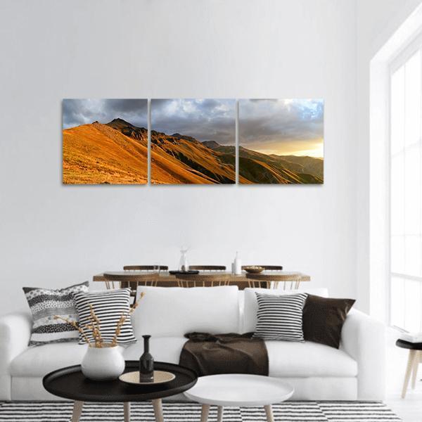 Autumn at Kackars Mountains Panoramic Canvas Wall Art in orange, yellow and blue, hung on a wall