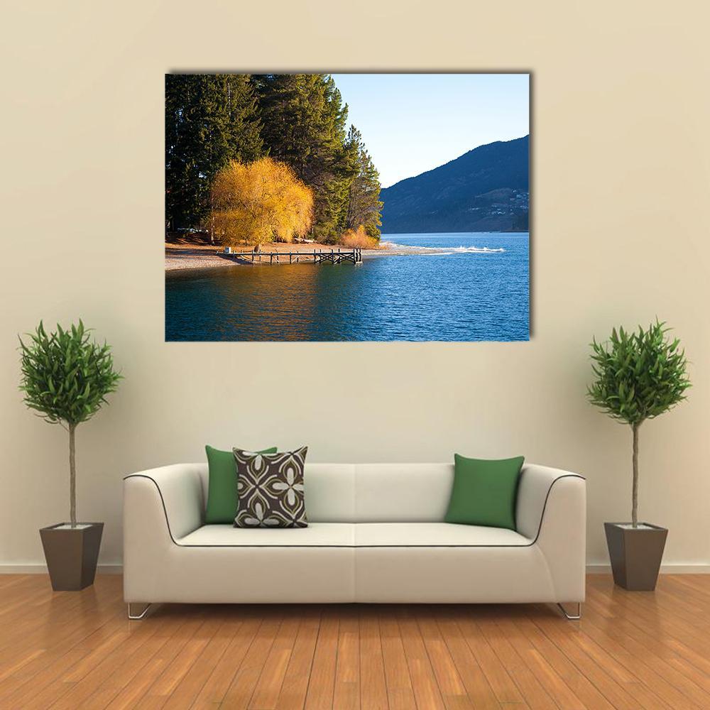 Autumn at Wakatipu Lake Canvas Wall Art in yellow, green and blue, single panel hung on a wall