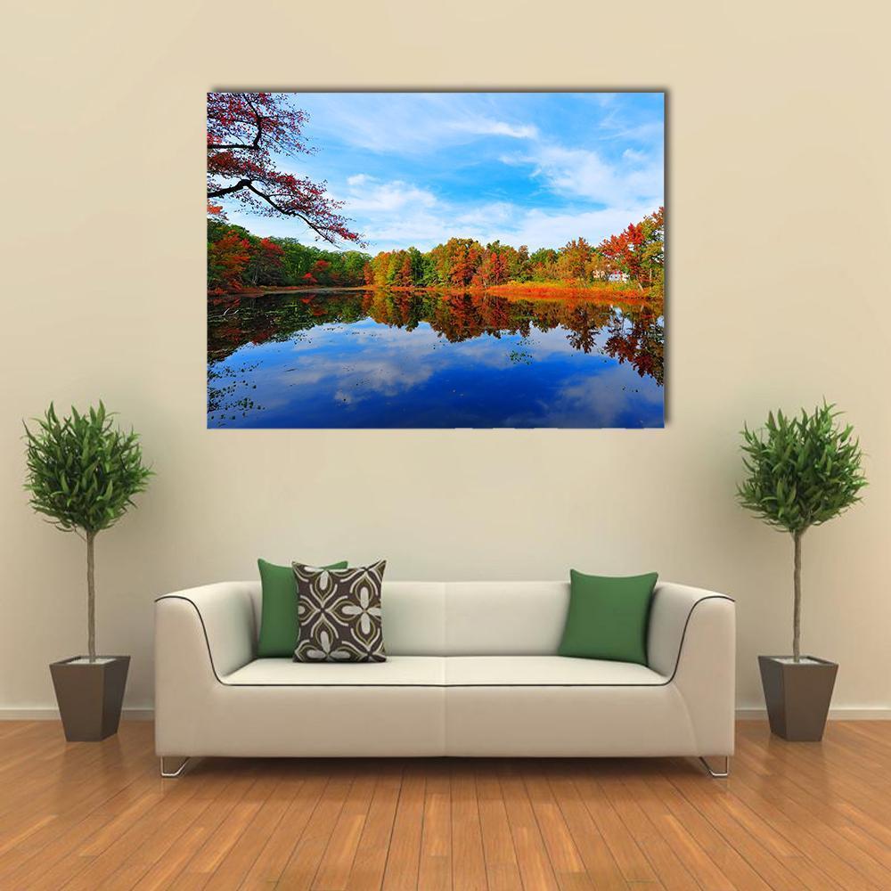 Autumn Pond Reflections Canvas Wall Art in orange, green and blue, single panel hung on a wall
