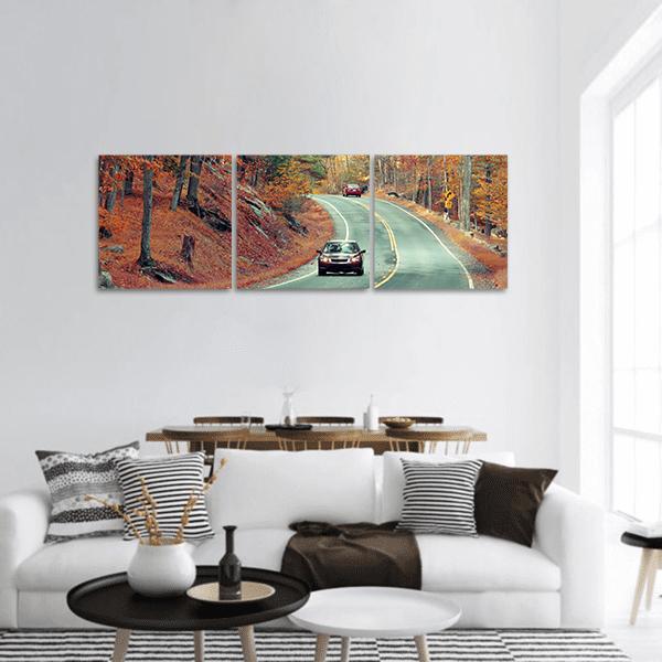 Cars on Autumn Road Panoramic Canvas Wall Art in gray, brown and orange, hung on a wall