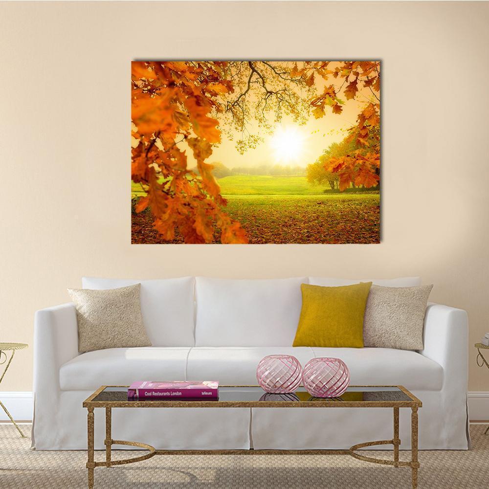 Autumn Forest with Sunlight Canvas Wall Art in orange, yellow and green, single panel hung on a wall