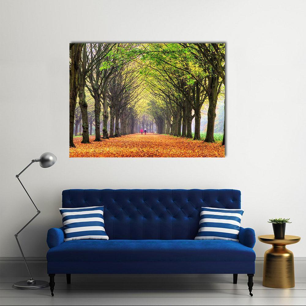 Autumn Path Through Amsterdam Forest Canvas Wall Art in orange, yellow and green, single panel hung on a wall