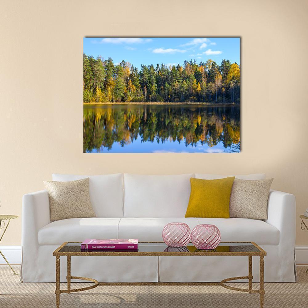 Autumn Forest Reflection in Pond Canvas Wall Art in yellow, green and blue, single panel hung on a wall