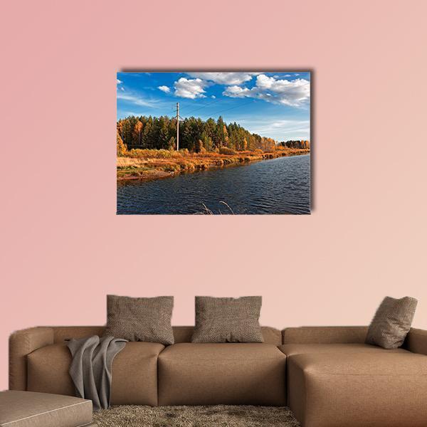 Autumn River Through Forest Canvas Wall Art in brown, orange and blue, single panel hung on a wall