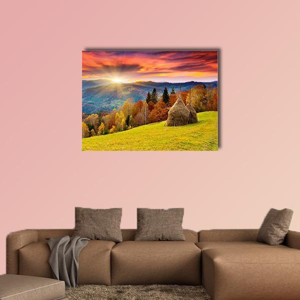 Autumn Mountain Landscape with Haystacks Canvas Wall Art in orange, yellow and blue, single panel hung on a wall