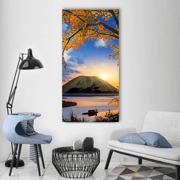 Autumn Mountain Lake with Fisherman Vertical Canvas Wall Art in orange, yellow and blue, single vertical panel hung on a wall