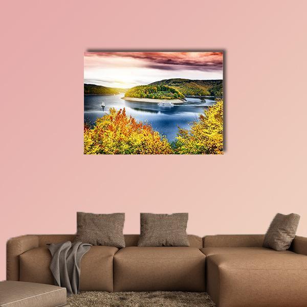 Autumn Lake with Boat at Sunset Canvas Wall Art in orange, yellow and blue, single panel hung on a wall