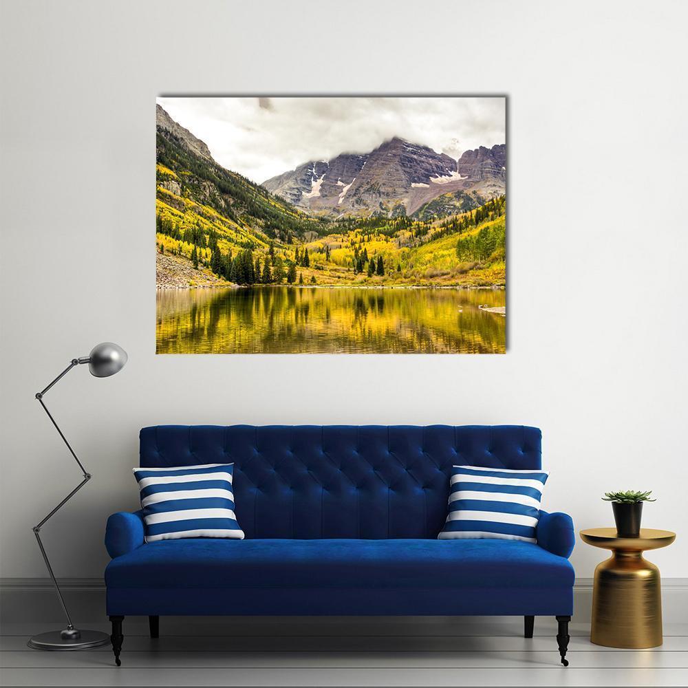 Serene Autumn Lake with Snow-capped Mountains Canvas Wall Art in gray, yellow and green, single panel hung on a wall