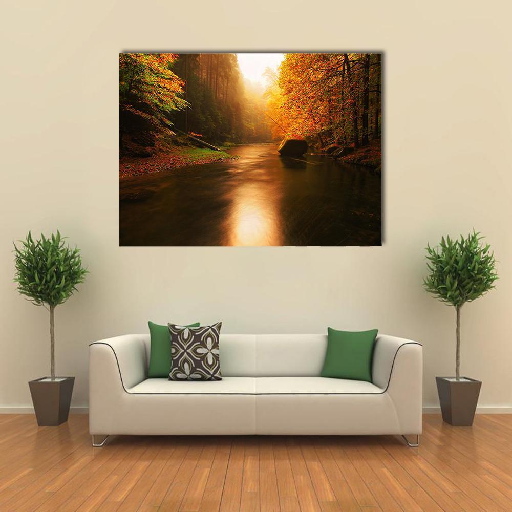 Autumn Mountain River Landscape Canvas Wall Art in brown, orange and yellow, single panel hung on a wall