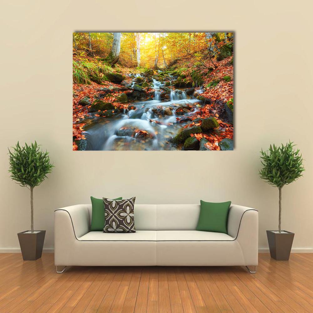 Autumn Forest Stream Canvas Wall Art in brown, orange and yellow, single panel hung on a wall
