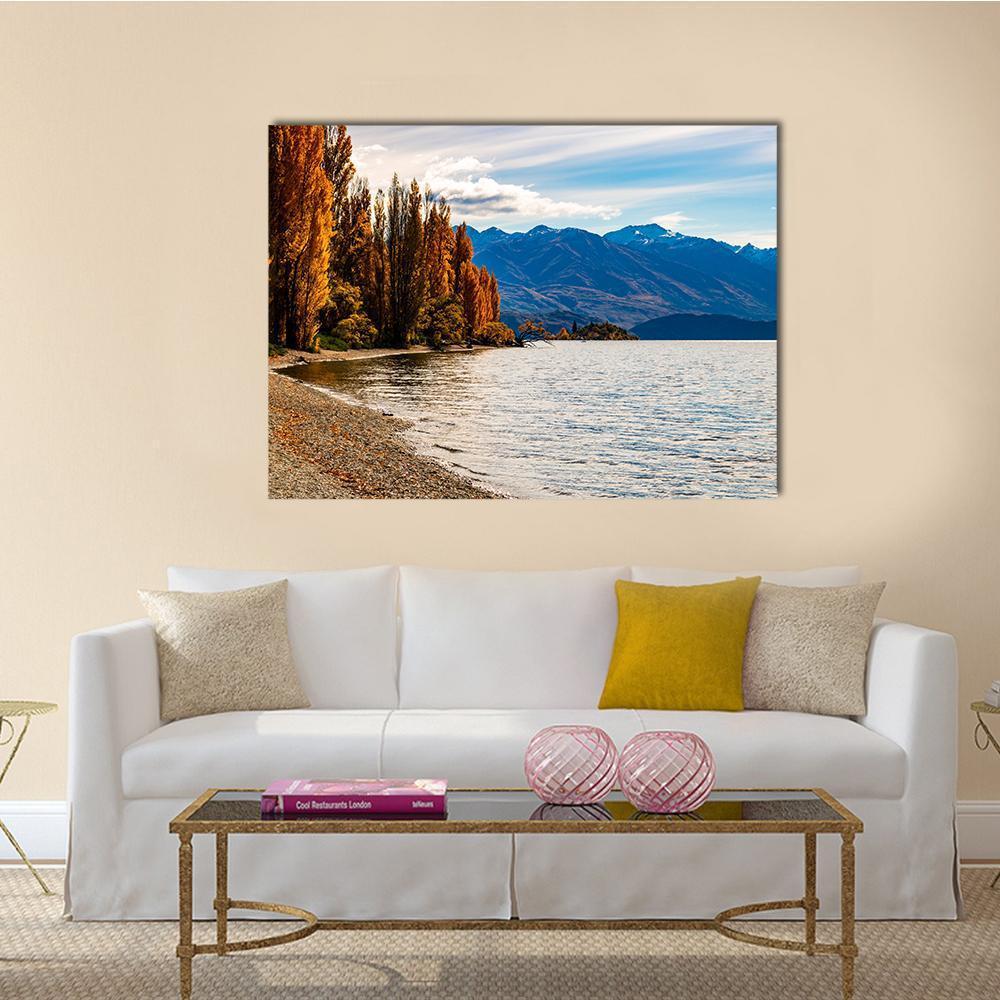 Autumn Trees at Wanaka Lake Canvas Wall Art in brown, orange and blue, single panel hung on a wall