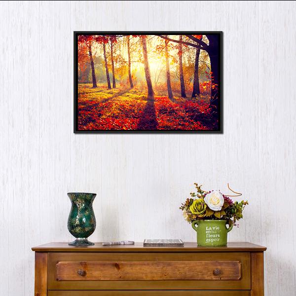 Autumn Trees with Sunbeams Canvas Wall Art in red, orange and yellow, framed canvas, product view on a white background