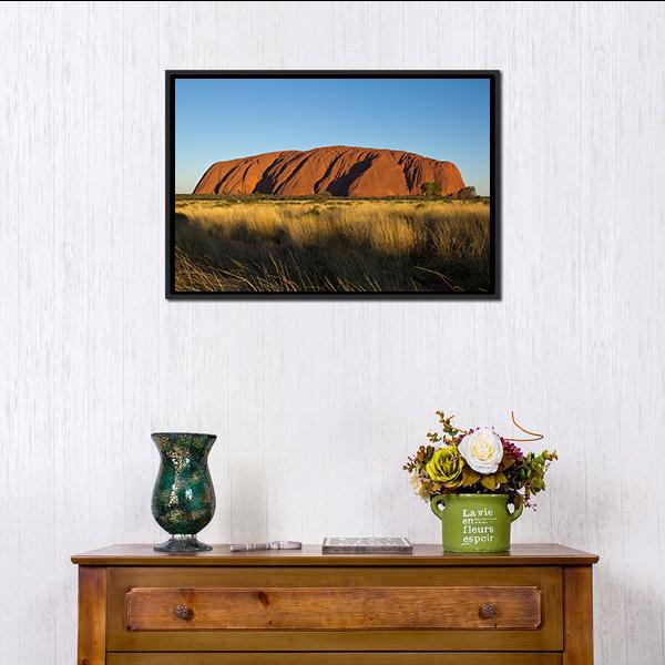 Ayers Rock in the Evening Canvas Wall Art in brown, yellow and blue, framed canvas, product view on a white background
