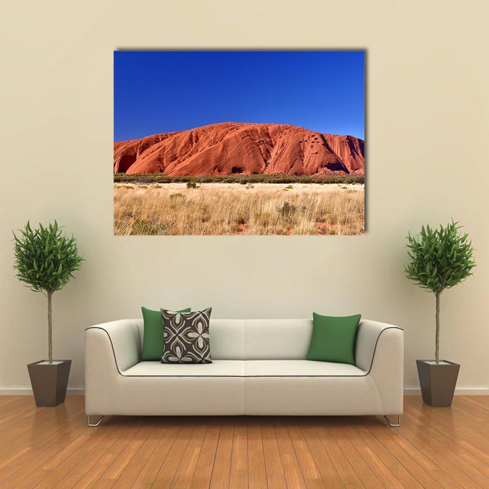 Ayers Rock Uluru Desert Landscape Canvas Wall Art in beige, red and blue, single panel hung on a wall