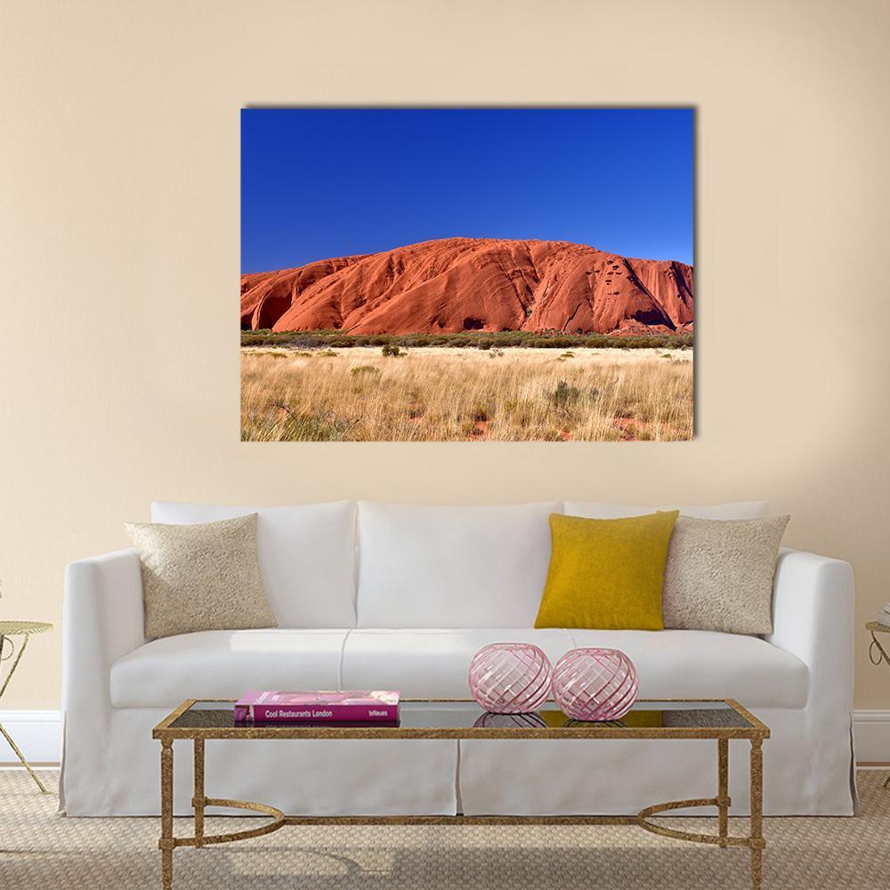 Ayers Rock Red Sandstone Landscape Canvas Wall Art in beige, red and blue, single panel hung on a wall