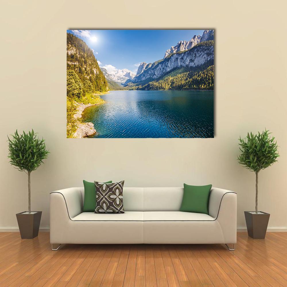 Azure Alpine Lake with Forested Mountains Canvas Wall Art in gray, green and blue, single panel hung on a wall