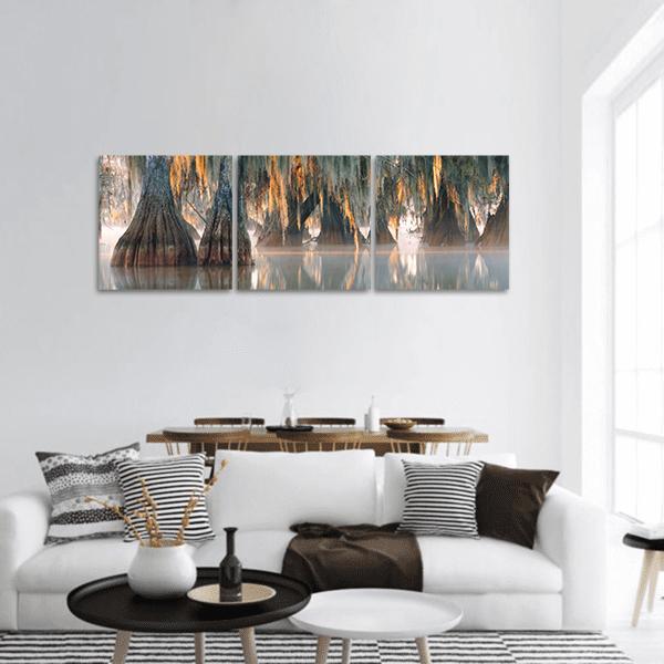 Bald Cypress Trees in Misty Swamp Panoramic Canvas Wall Art in gray, brown and orange, hung on a wall