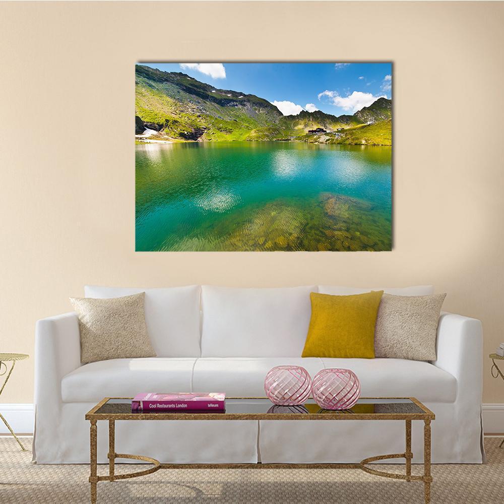 Balea Lake Romania Canvas Wall Art in green and blue, single panel hung on a wall