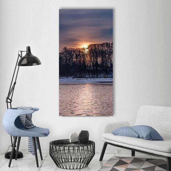 Winter Sunset Over Baltic Coast Vertical Canvas Wall Art in gray, orange and purple, single vertical panel hung on a wall