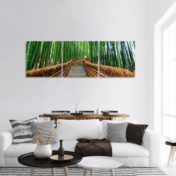 Stone Steps Through Bamboo Forest Panoramic Canvas Wall Art in brown and green, hung on a wall