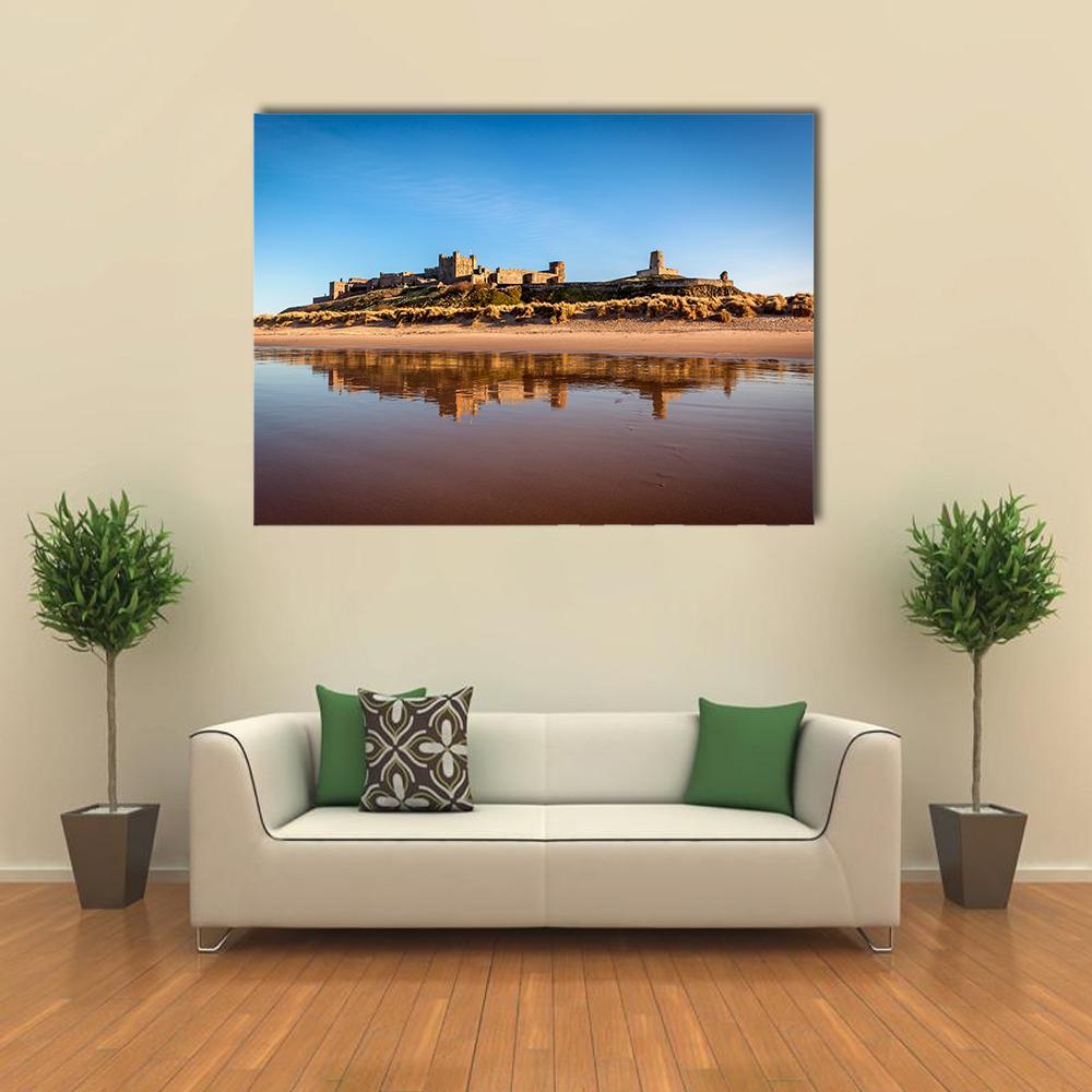 Bamburgh Castle on Sandy Beach Canvas Wall Art in beige, brown and blue, single panel hung on a wall