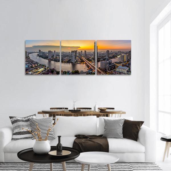 Bangkok Business District at Dusk Panoramic Canvas Wall Art in orange, yellow and blue, hung on a wall