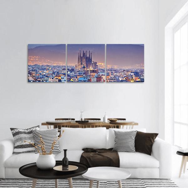 Barcelona at Night Panoramic Canvas Wall Art in yellow, blue and purple, hung on a wall