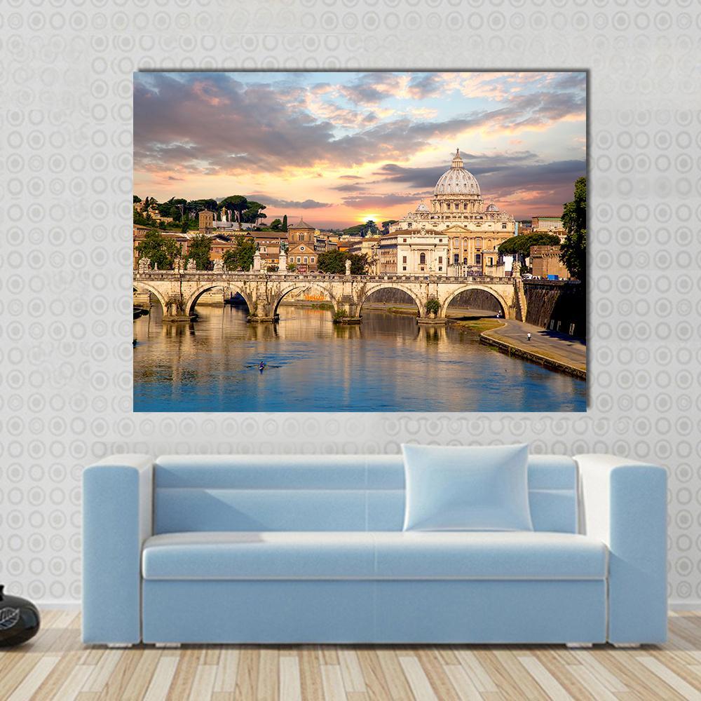 St. Peter's Basilica and Sant'angelo Bridge Canvas Wall Art in beige, orange and blue, single panel hung on a wall