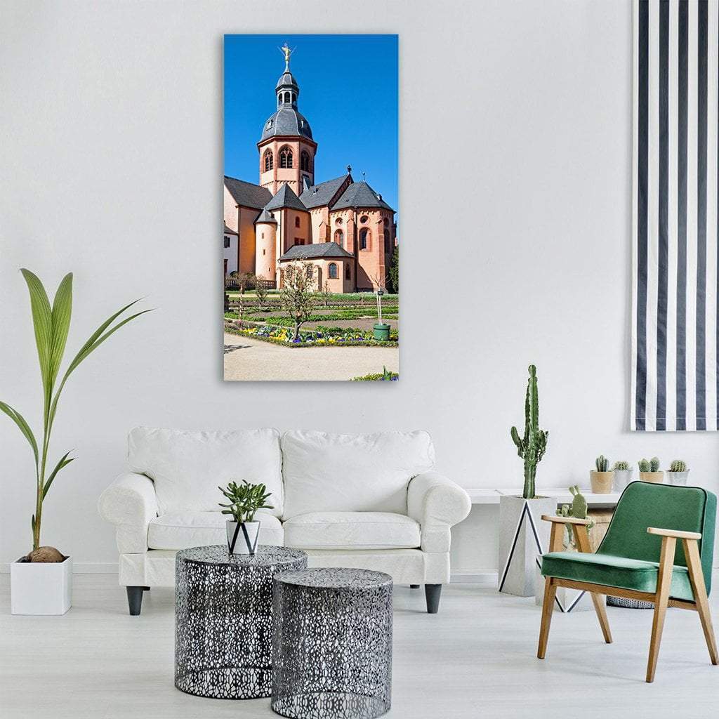Romanesque Basilica and Garden in Germany Vertical Canvas Wall Art in beige, brown and blue, single vertical panel hung on a wall