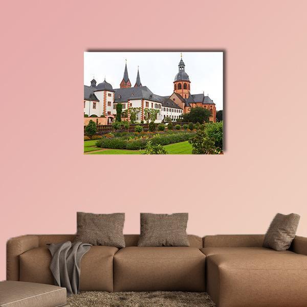 Basilica with Garden and Distinctive Spires Canvas Wall Art in white, orange and green, single panel hung on a wall