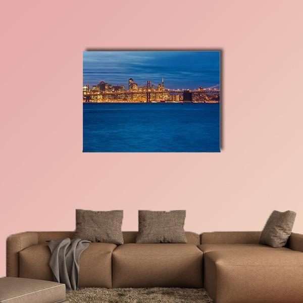 Bay Bridge at Night, San Francisco Canvas Wall Art in black, orange and blue, single panel hung on a wall