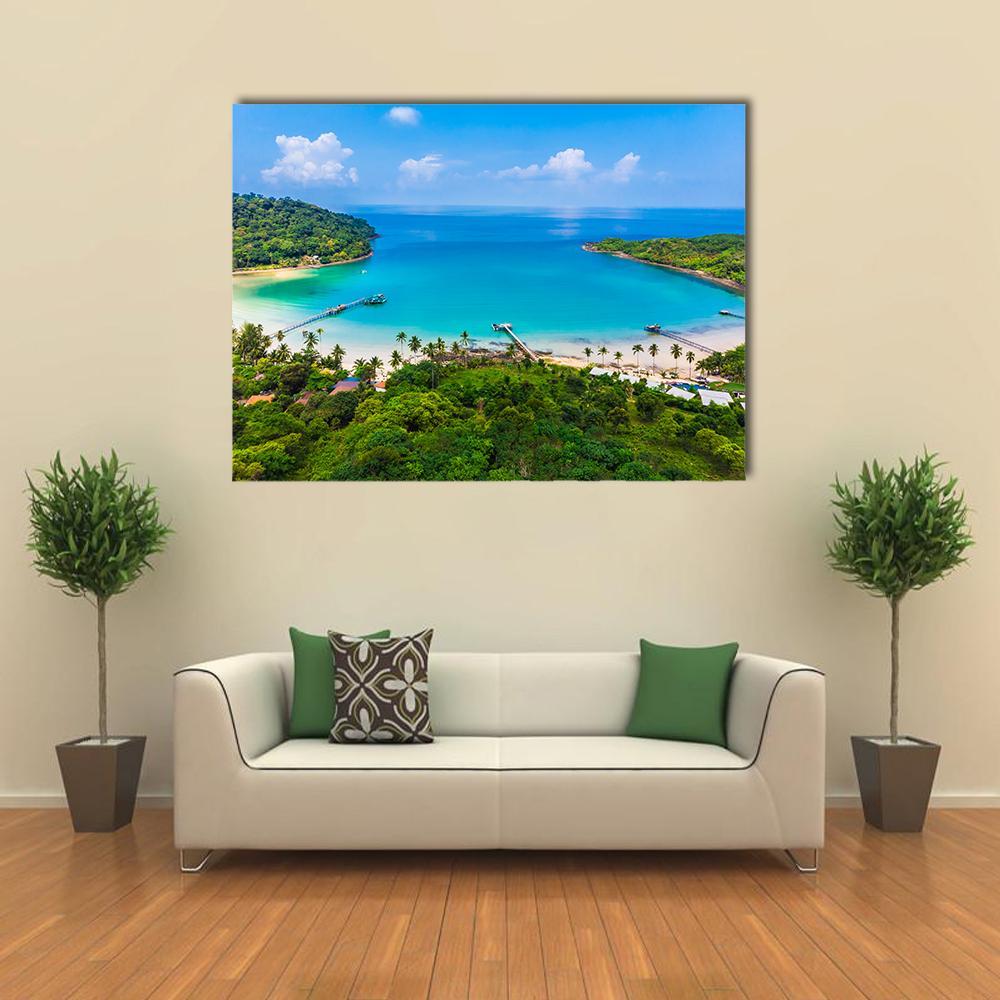 Tropical Island Beach with Pier Canvas Wall Art in green and blue, single panel hung on a wall