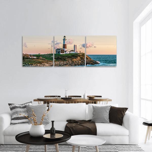 Montauk Lighthouse at Dusk Panoramic Canvas Wall Art in beige, orange and blue, hung on a wall