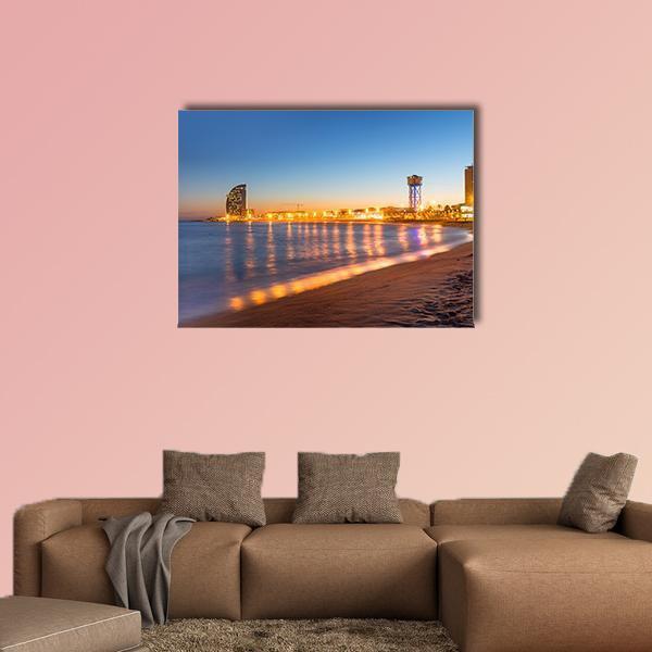 Barcelona Beach at Sunset Canvas Wall Art in orange, yellow and blue, single panel hung on a wall